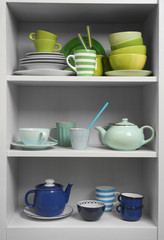 Tableware on shelves in the kitchen cupboard