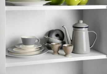Tableware on shelf in the kitchen cupboard