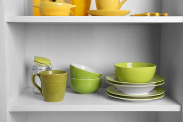 Tableware on shelves in the kitchen cupboard