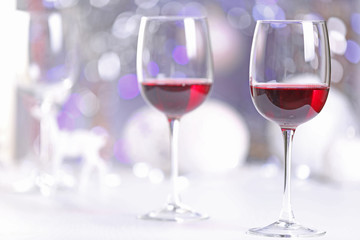Wineglasses on blurred lights background