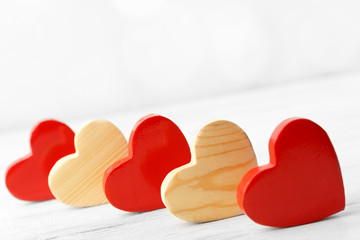 Wooden hearts on light background