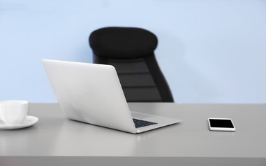Modern workplace with office chair and laptop