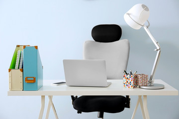 Modern workplace with office chair and laptop