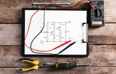 Electrical drawing with tools on wooden table, top view