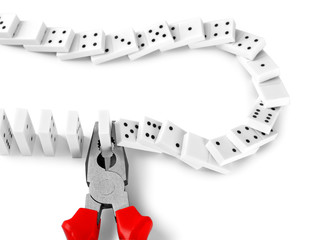 Dominoes with pliers, isolated on white