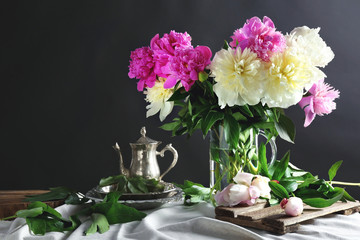 Composition with beautiful peony flowers on dark background