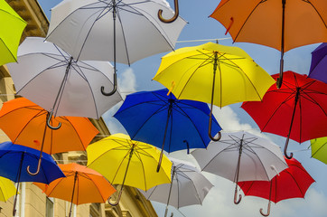 Colorful umbrellas and blue sky as a street decoration