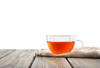 Glass cup of tea on wooden table