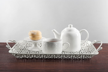 White ceramic tea set on wooden table