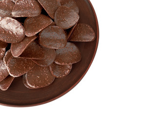 Chocolate chips in brown plate on white background