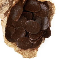Chocolate chips in parchment on white background