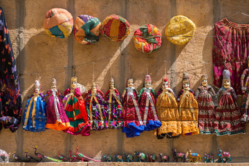 Souvenir Rajasthan puppets hanging in the street shop of Jodhpur, India