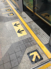 A view of arrows on platform in a long view. Taken on July 3, 2016 at BTS Chong Nonsi station in Bangkok Thailand.