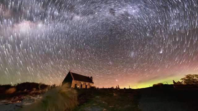 Aurora Borealis or The Southern Light and Star Trails above Church Of Good Shepherd, Tekapo, New Zealand. Camera Zoom Out