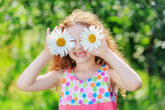 Child with daisy eyes, on green bokeh background