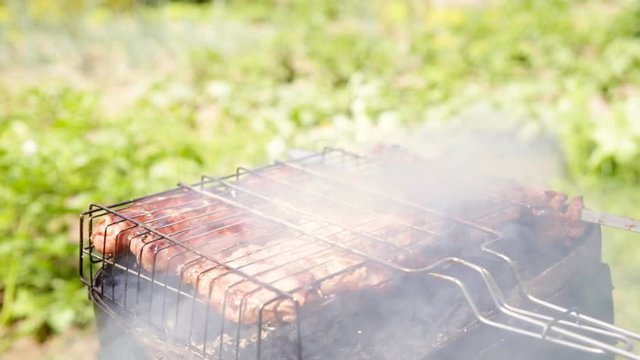 Barbequed meats are roasted on the grill