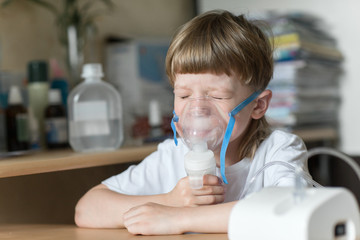 child holds a mask vapor inhaler