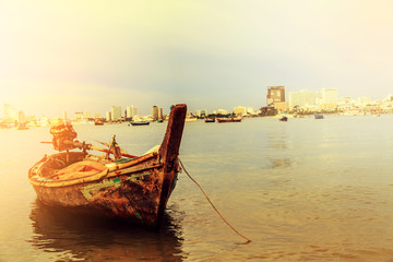 Selling an old rowboat tied to the sea, Pattaya, Chonburi, Thailand.