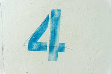 the number 4 on the dirty white wall