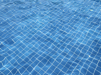 Fototapeta na wymiar Blue swimming pool rippled water detail 