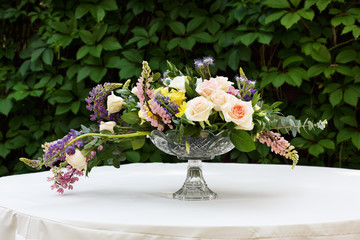 Beautiful flower bouquet outdoors. Wedding floristic decoration at white table