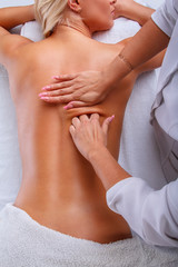 Female enjoing relaxing back massage.