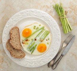 fried eggs with asparagus on a plate - healthy Breakfast