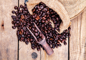 Coffee, bag and scoop on old rusty background