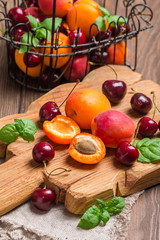  Apricots and cherries on rustic  background