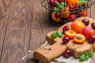  Apricots and cherries on rustic  background