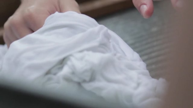 women wash using a old fashioned washboard 