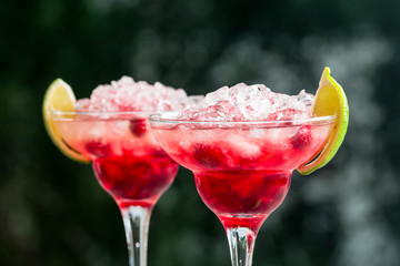 margarita cocktail with lime and raspberries
