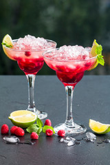 margarita cocktail with lime and raspberries