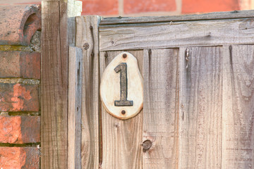 House number 1 sign on gate