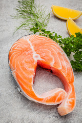 Fresh salmon fillet slice on dark stone background with fennel a