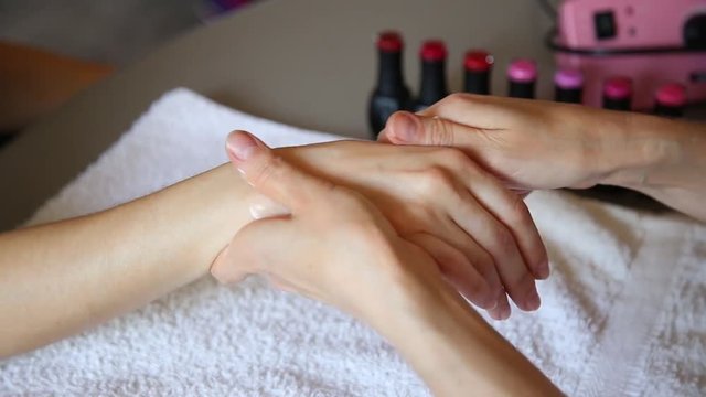 Cosmetician doing hand massage before paints nails of client. Manicure nail care in a beauty salons. spa treatment for hands