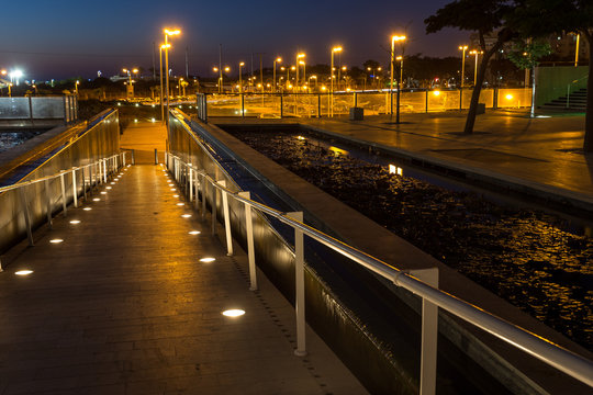 lighted walkway with a fountain on each side