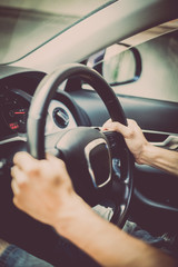 Naklejka premium Hands on steering wheel