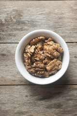 Walnut kernel in a white bowl