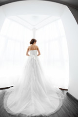 Brides beauty. Young woman in wedding dress indoors