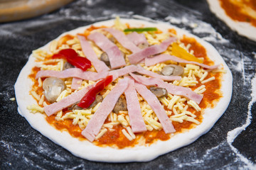 Chef preparing pizza for baking