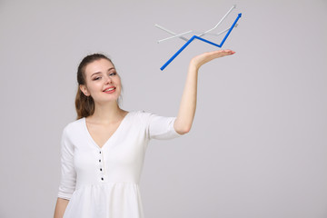 Businesswoman working with growth graph on grey background