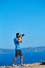 panoramic view on Balos beach, Crete, Greece. Man, traveller and photographer stands on the cliff and taking photo