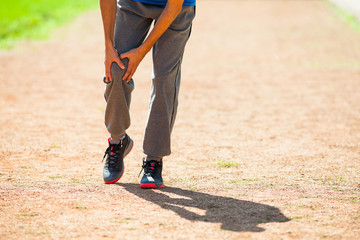 Man is having pain in leg while jogging.