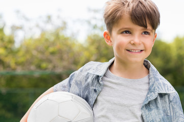 Young boy holding soccer ball