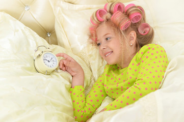 girl in hair curlers awaked up
