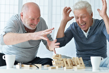 senior men playing  board game