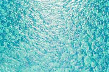 Closeup surface water in a blue swimming pool textured background in the afternoon