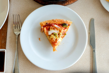 Piece of pizza in dish 