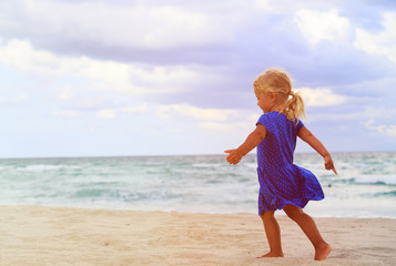 happy cute little girl run on beach